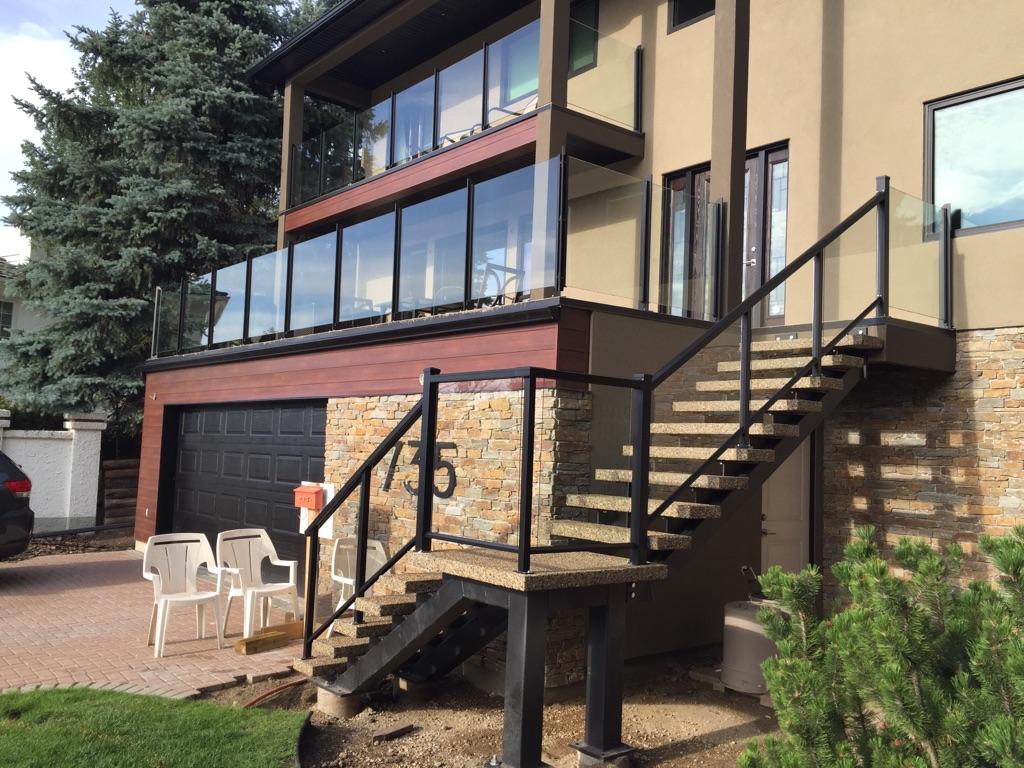 Glass Railings for Upper Deck and Stairs – Edmonton Installation Upper deck and staircase featuring custom glass railings installed by Proshield Metal Works in Edmonton.