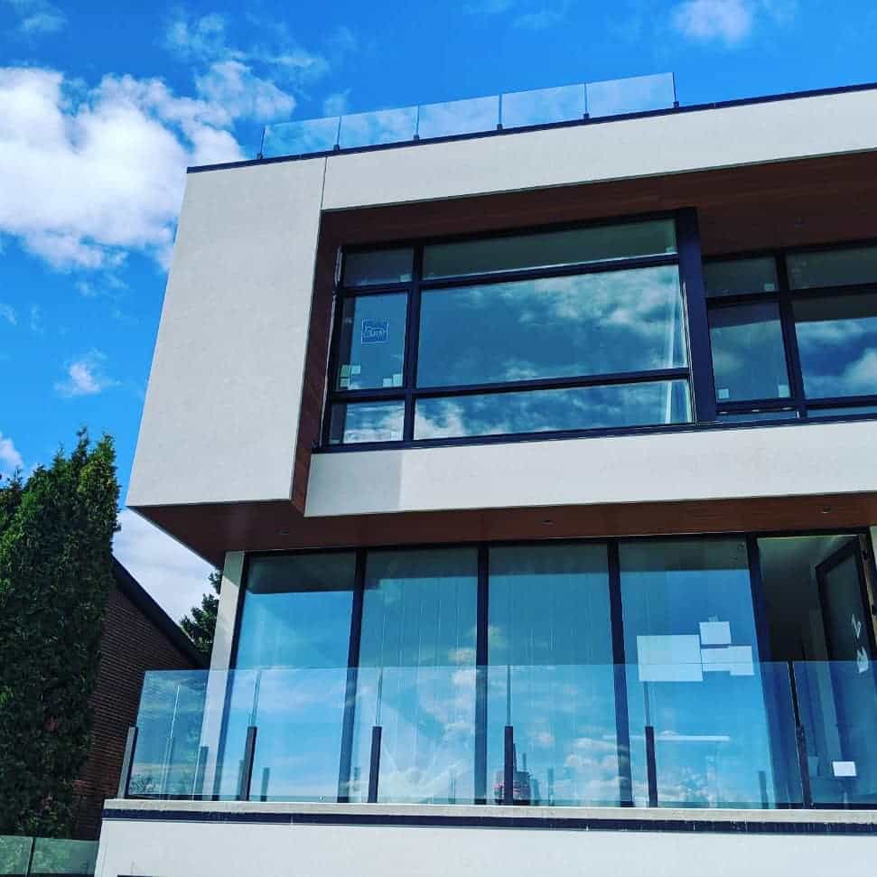 Glass Railing Installation – Modern & Secure by Proshield MW Frameless glass railing installed on a modern balcony by Proshield Metal Works in Edmonton.